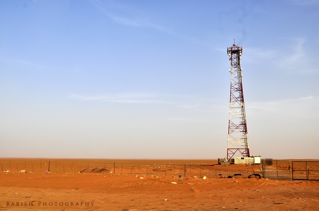 Desert X Closing 2023 tower with speakerphones in the desert with a man off to the side