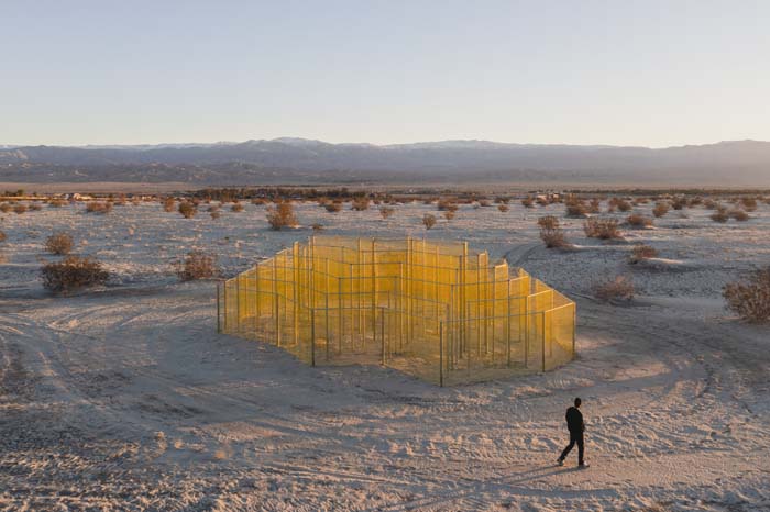 yellow chain sculpture in the desert