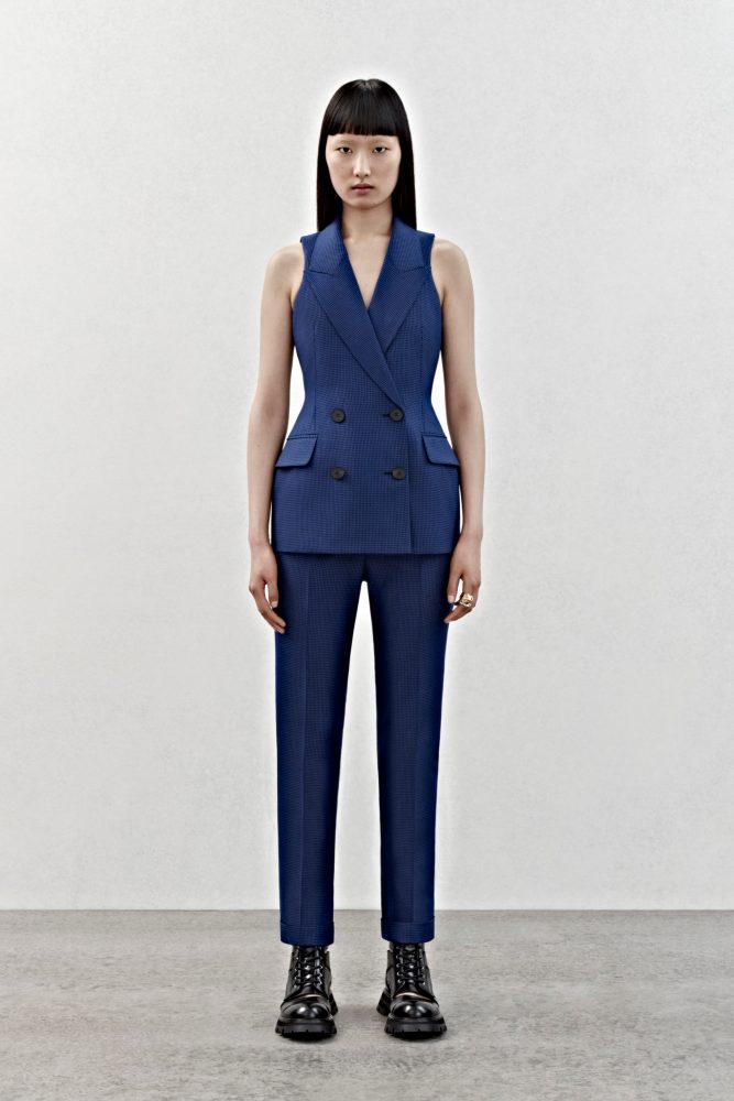 A sleeveless double-breasted tailored jacket and bumster trousers in ultramarine houndstooth check wool.
