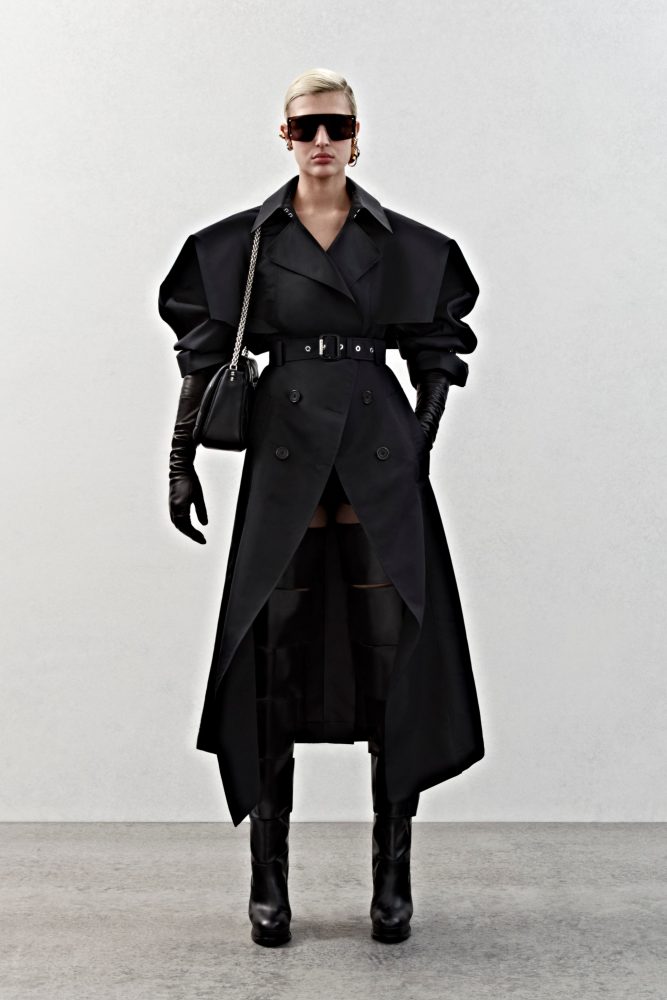 A trench coat in black poly faille.