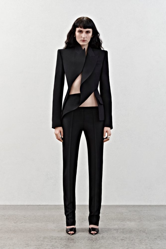 A deconstructed tailored jacket and bumster trousers in black wool.