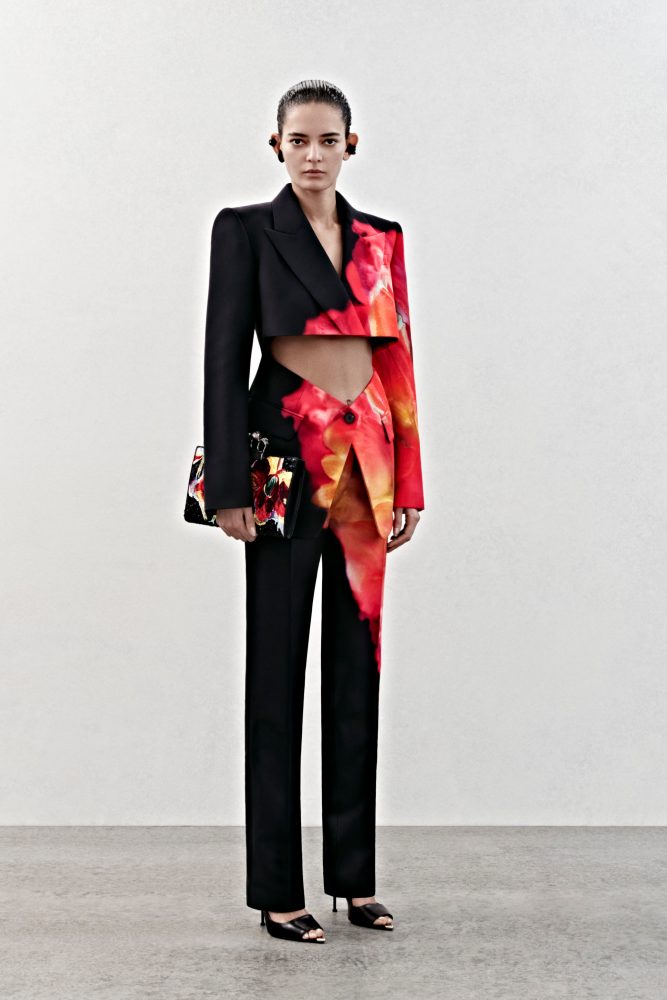 A slashed tailored jacket and low-waisted trousers in black viscose cady with a solarized petal print.