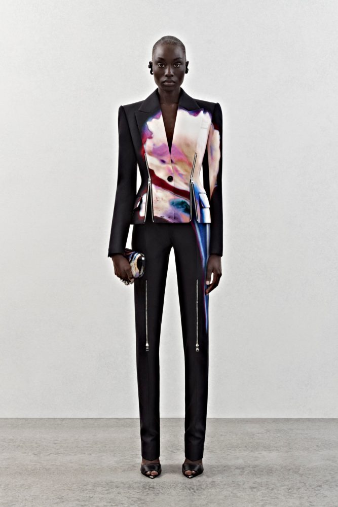 A single-breasted tailored jacket and trousers in black viscose cady with a solarized flower print and silver metal zip detailing.