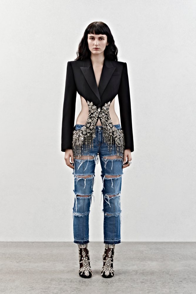 A cutaway single-breasted tailored jacket with crystal embroidery and slashed bumster trousers in blue denim.