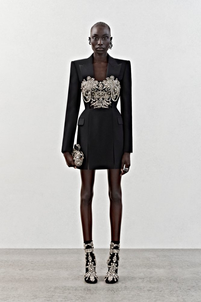 A tailored tuxedo jacket in black wool with crystal embroidery.