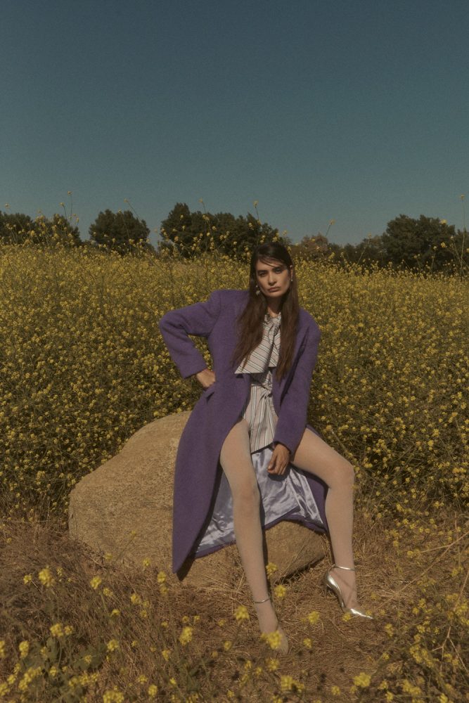 Natalia Bonifacci wears coat and dress by MSGM, earrings by Mondo Mondo, Necklace by Mia Vesper necklace stylist's shoes and tights. image 1 photographed by Mathilde Bresson