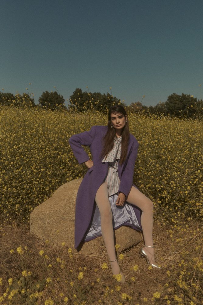 Natalia Bonifacci wears coat and dress by MSGM, earrings by Mondo Mondo, Necklace by Mia Vesper necklace stylist's shoes and tights. image 1 photographed by Mathilde Bresson