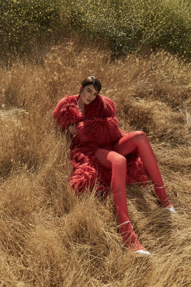 Natalia Bonifacci wears coat by MSGM, earrings by Hannah Jewett, necklace by Hernán Herdez, and stylist's shoes and tights. image 1 photographed by Mathilde Bresson