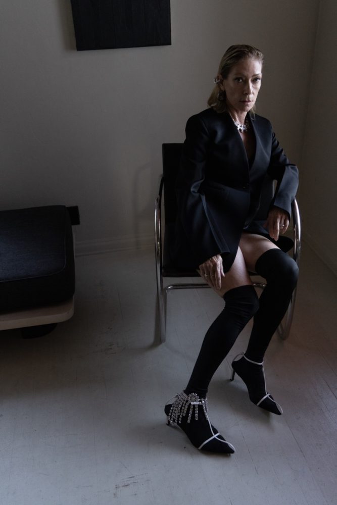Kim Gordon wears JIL SANDER dress, coat, shoes and jewelry. Photographed by Jason Renaud. Styled by BJ Panda Bear and Paul Rizzo. Hair by Paul Rizzo using Bumble and Bumble Makeup by Nicole Servin Joshua Nixon Kim Gordon wears JIL SANDER dress, coat, shoes and jewelry.