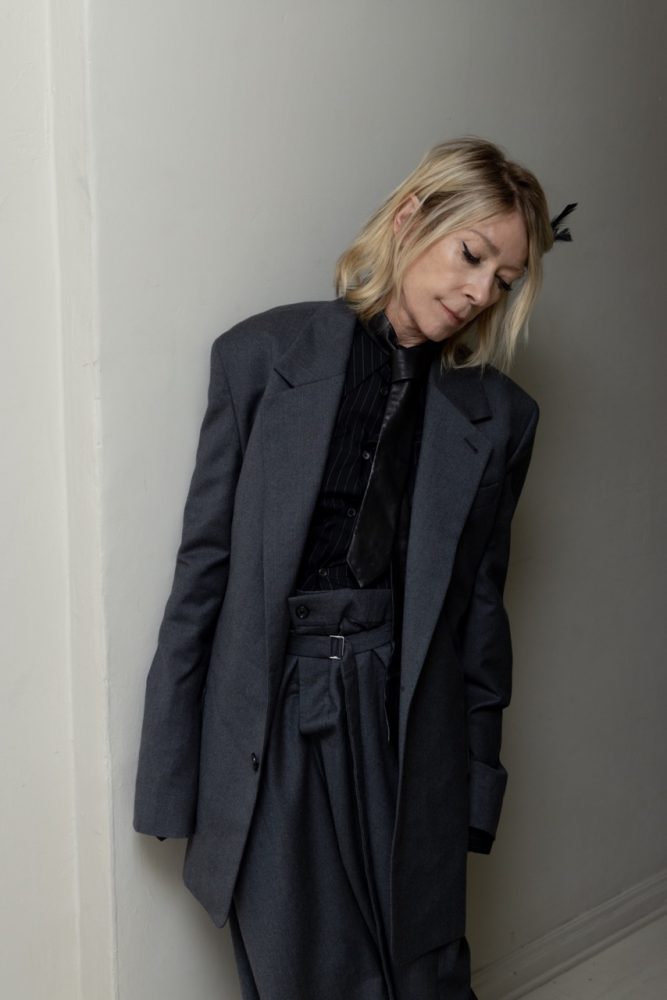 Kim Gordon wears ANN DEMEULEMEESTER coat, suit, shirt, tie. Photographed by Jason Renaud. Styled by BJ Panda Bear and Paul Rizzo. Hair by Paul Rizzo using Bumble and Bumble Makeup by Nicole Servin Joshua Nixon