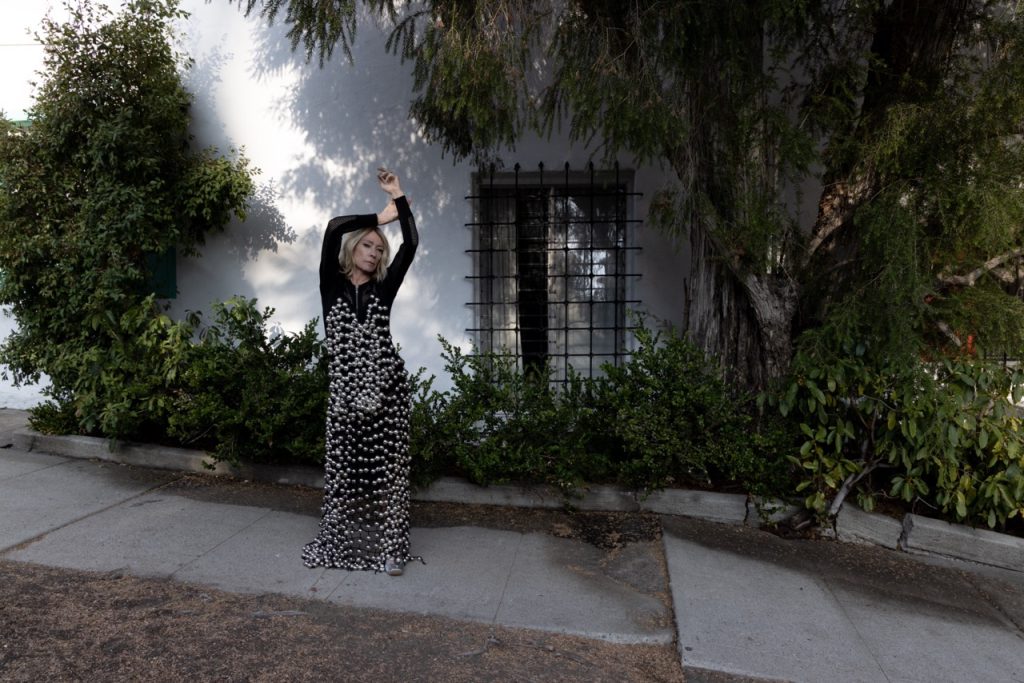 Kim Gordon wears MAISIE WILEN dress, BALMAIN bodysuit available at Paume Los Angeles, and SARA WONG shoes. Photographed by Jason Renaud. Styled by BJ Panda Bear and Paul Rizzo. Hair by Paul Rizzo using Bumble and Bumble Makeup by Nicole Servin Joshua Nixon