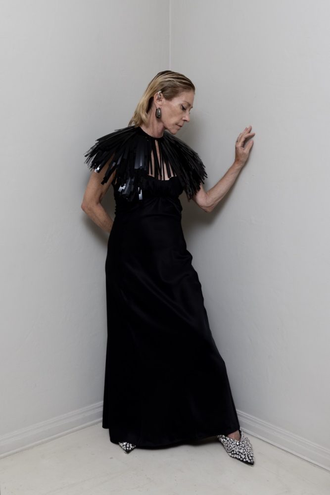 Kim Gordon wears JIL SANDER dress, cape, shoes and jewelry. Photographed by Jason Renaud. Styled by BJ Panda Bear and Paul Rizzo. Hair by Paul Rizzo using Bumble and Bumble Makeup by Nicole Servin Joshua Nixon
