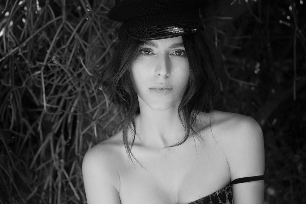 Tatiana Luter wears DOLCE & GABBANA dress and GAULTIER hat available at the Archive x Yana BW