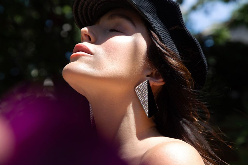 Tatiana Luter wears SAINT LAURENT earrings and GAULTIER hat available at the Archive x Yana