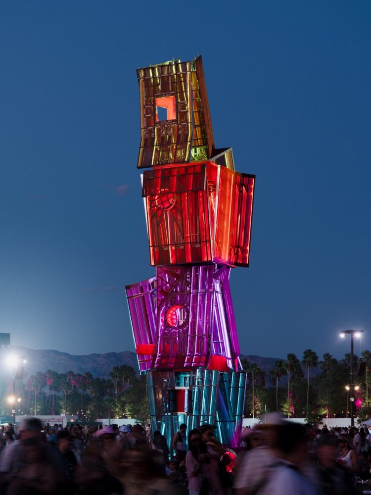 The Art of Coachella 2026 | Monuments of Comfort Visage Brut, a towering steel sculpture by The Los Angeles Design Group (LADG). Photographed by Lance Gerber. night time