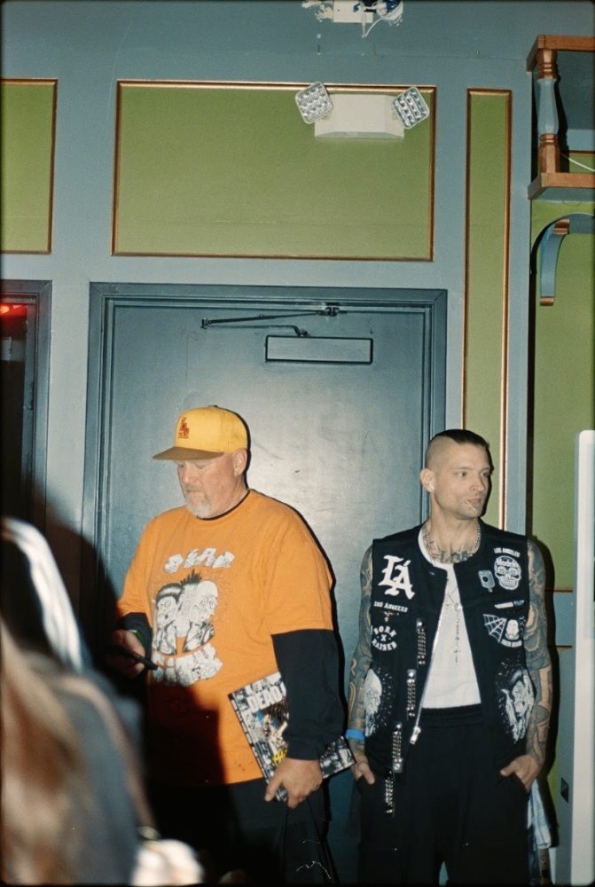 Dead City Punx Take Back LA Still from Punx: The Art of Dead City and Friends. orange tee